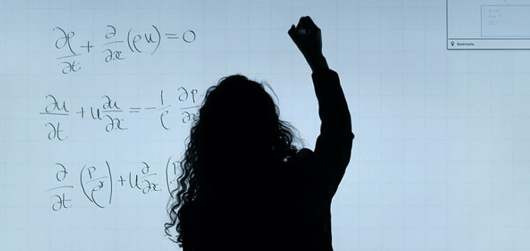 woman writing on whiteboard