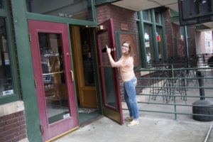 Emma pointing at the Apothecary doors